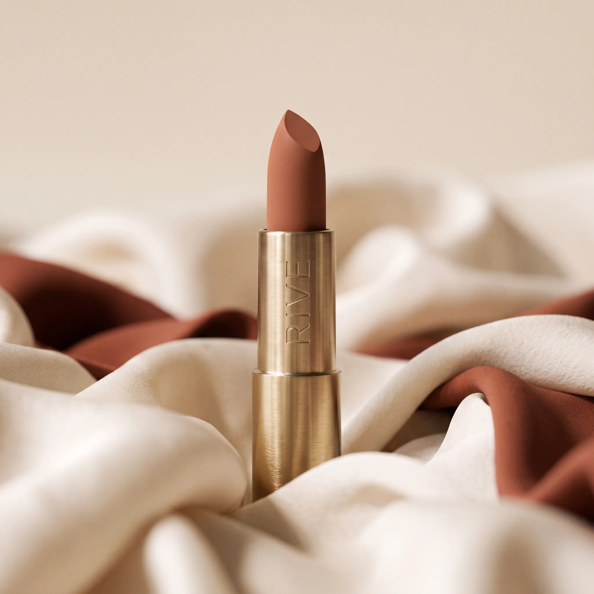 Rive lipstick amid draped silk